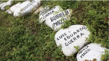  ??  ?? Stones with the names of those murdered by armed groups