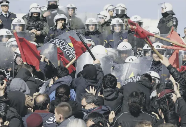  ?? PICTURE: THANASSIS STAVRAKIS/AP ?? Police clash with protesters on the steps of parliament in Athens at the end of a rally against a new austerity bill