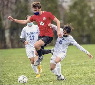  ?? Photos by James Franco / Special to the Times Union ?? Niskayuna’s Jordan Angrist jumps to get past Albany’s Naykawwah Blat during their game Saturday. Angrist scored a first-half goal for the Silver Warriors.