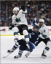  ?? JOHN WOODS — THE ASSOCIATED PRESS ?? Winnipeg’s Nikolaj Ehlers (27) collides with the Sharks’ Brenden Dillon, left, as San Jose’s Evander Kane trails the action in the second period Friday night in Winnipeg.