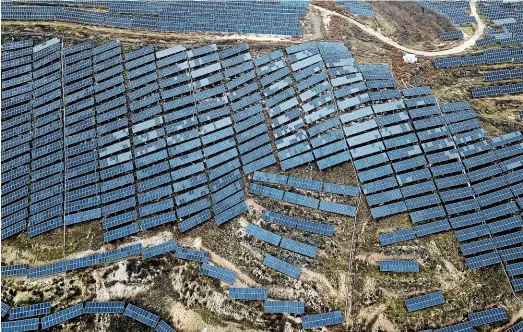  ?? AP ?? Plans to get a fifth of China’s energy from non-fossil fuel sources, such as this solar farm in Shanxi Province, by 2025 would mean growing its wind and solar generation by an average of 12 per cent a year.