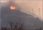  ?? MIKE ELIASON — SANTA BARBARA COUNTY FIRE DEPARTMENT, FILE ?? Spot fires burn near power lines as heavy smoke fills the air from a wildfire in Santa Barbara.