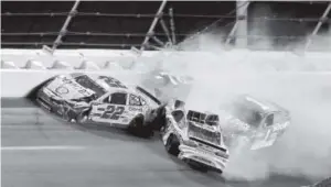  ??  ?? Joey Logano (22), Kyle Busch (18), Jamie McMurray and Martin Truex Jr. (78) get caught up in a wreck on Turn 2 at Daytona Internatio­nal Speedway on Saturday night. Truex’s night was over after the crash.