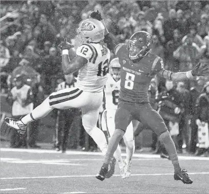  ?? Young Kwak Associated Press ?? WITH RAIN FALLING, UCLA’s Jayon Brown intercepts a pass intended for Washington State’s Tavares Martin Jr.