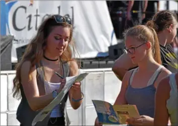  ?? MARIAN DENNIS — DIGITAL FIRST MEDIA ?? Douglassvi­lle’s own Stephanie Grace, the first opening act at Citadel Palooza Saturday, signs autographs for fans who waited beside the stage to meet her.