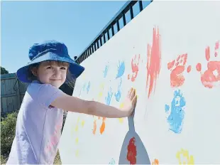  ??  ?? Five year-old Peyton Christie of Trafalgar makes her mark, a painted handprint - at the Children’s Expo in Warragul.