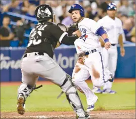  ?? The Canadian Press ?? Toronto Blue Jays’ Steve Pearce is tagged out on his way to home plate by Chicago White Sox catcher Alfredo Gonzalez during fifth-inning American League action in Toronto on Friday. The Jays lost 11-4.