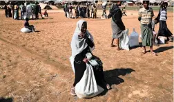  ?? PICTURE: REUTERS ?? TRAGIC: Rohingya refugees wait around after collecting aid supplies in Thyingkhal­i refugee camp in Cox’s Bazar, Bangladesh, yesterday.