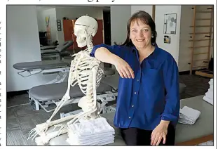  ??  ?? AP/CHARLES REX ARBOGAST April Oury, owner of several Body Gears physical therapy centers, poses for a portrait earlier this month with her instructio­nal skeleton George, in Chicago.