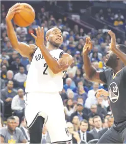  ??  ?? OAKLAND: Brooklyn Nets’ Jarrett Jack passes over Golden State Warriors’ Draymond Green during the first half of an NBA basketball game, Saturday, in Oakland, Calif. — AP