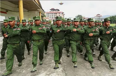  ??  ?? Ready to serve: United Wa State Army soldiers marching during special display of their military strength to the media. — Reuters