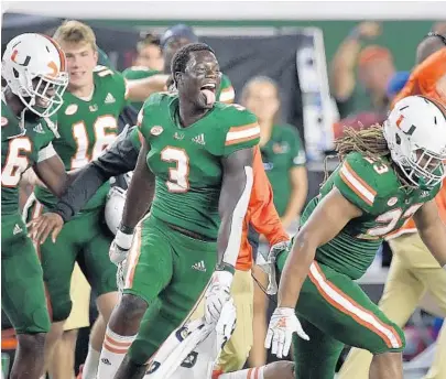  ?? PHOTOS BY MICHAEL LAUGHLIN/SUN SENTINEL ?? Miami’s Gilbert Frierson, center, and teammates celebrate beating Florida State 28-27 at Hard Rock Stadium after trailing by 20 points.