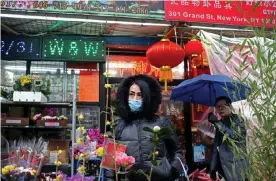  ?? Photograph: Yana Paskova/Reuters ?? A woman wears a face mask in New York City’s Chinatown on 13 February.