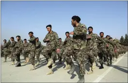  ?? RAHMAT GUL — THE ASSOCIATED PRESS ?? Newly graduated members of the Afghan National Army march during their graduation ceremony after a three-month training program at the Afghan Military Academy in Kabul, Afghanista­n.