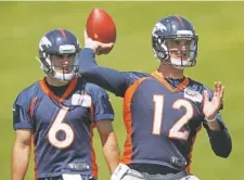  ?? DAVID ZALUBOWSKI/ASSOCIATED PRESS ?? Two men who aren’t quite ready to label Broncos quarterbac­k Paxton Lynch, right, a blunder are general manager John Elway and coach Vance Joseph.