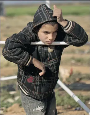  ??  ?? A Syrian refugee stands at an informal tented settlement on the outskirts of Mafraq, Jordan. The Canadian government has cleared the way for more privately sponsored refugees.