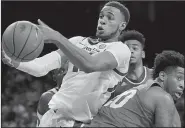  ?? NWA Democrat-Gazette/CHARLIE KAIJO ?? Arkansas Razorbacks forward Daniel Gafford (10) tries to control a loose ball during Sunday’s game at Walton Arena in Fayettevil­le. Gafford finished with a career-high 27 points, 12 rebounds, 3 blocked shots and 2 steals.