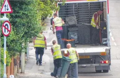  ??  ?? The new recycling bins being delivered to properties in North Street, Ashford