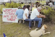  ?? AP PHOTOS ?? DAY OF PRAYER: People take a break for a makeshift worship service in Port Aransas, Texas, above. Residents and volunteers have a lot of work ahead in flooddamag­ed areas, such as Spring, Texas, left.