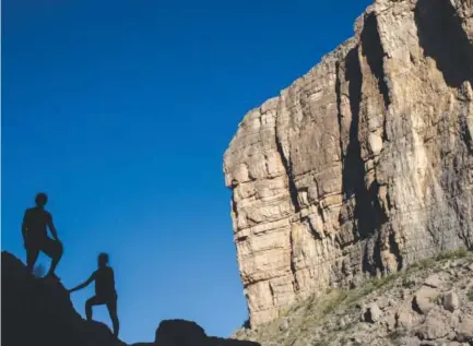  ??  ?? Tourists pose for photos in Santa Elena Canyon near a cliff face that is inMexico, on the banks of the Rio Grande river in Big Bend National Park in Texas. Here the Rio Grande slides between two sheer cliff faces, one inMexico and one in the United...