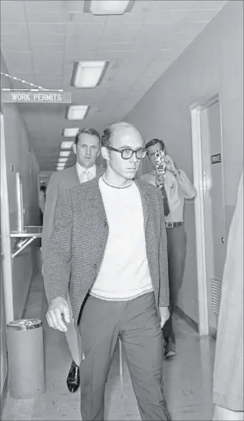  ?? Las Vegas Review-Journal file photo ?? Russell Payne, 25, is taken through a corridor at the Clark County courthouse after surrenderi­ng in court on a charge of murdering his parents.