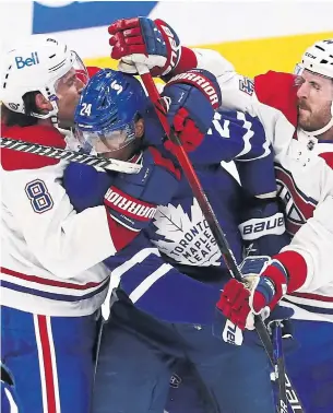  ?? RICHARD LAUTENS TORONTO STAR FILE PHOTO ?? Leafs forward Wayne Simmonds takes a pounding, sticks and all, from Canadiens defencemen Ben Chiarot and Joel Edmundson in Game 2 of their playoff series in May.