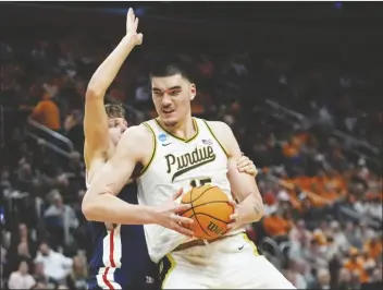  ?? PAUL SANCYA/AP ?? PURDUE CENTER ZACH EDEY (15) is defended by Gonzaga forward Ben Gregg during the second half of a Sweet 16 game tournament on Friday in Detroit.