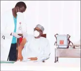  ??  ?? President Muhammadu Buhari receiving COVID- 19 Vaccine from his Chief Personal Physician, Dr. Suhayb Rafindadi Sanusi at the State House Abuja… yesterday