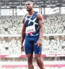  ?? Photo — AFP ?? Gatlin prepares to compete in a heat of the men’s 100m during an athletics test event for the Tokyo Olympics at the National Stadium in Tokyo.