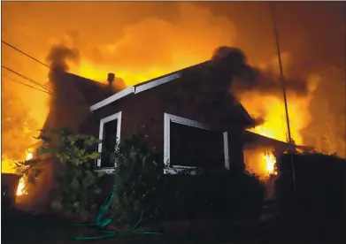  ?? PHOTO BY DYLAN BOUSCHER ?? Flames engulf a house on Big Basin Highway in Boulder Creek on Aug. 21. As of Tuesday, 1,431 structures had been lost in the fire.