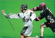  ?? SARAH GORDON/THE DAY ?? Brett Manney of the New England Black Wolves (13) carries the ball past the Calgary Roughnecks’ Creighton Reid (8) during a game on April 8, 2018 at Mohegan Sun Arena.