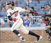  ?? JOHN BAZEMORE / ASSOCIATED PRESS ?? Braves third baseman Johan Camargo follows through on a double in the second inning of an 8-5 home win Saturday over Arizona.