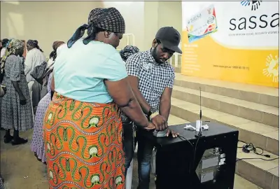  ?? Picture: SANDILE NDLOVU ?? UNCERTAINT­Y MOUNTS: A pensioner gets her grant at a pay point in Jeppes Reef, Mpumalanga