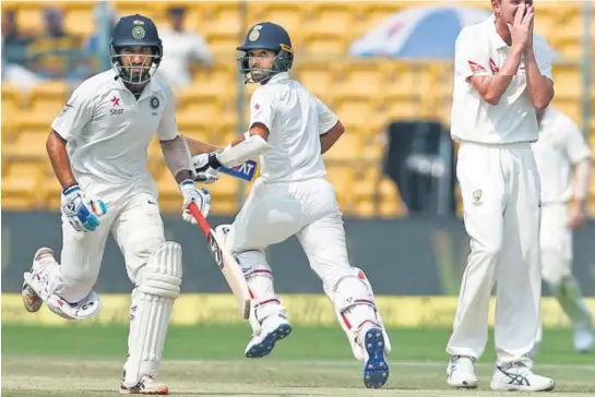  ?? REUTERS ?? Cheteshwar Pujara (79 n.o) and Ajinkya Rahane (40 n.o) provided India the lead against Australia at the Chinnaswam­y Stadium.