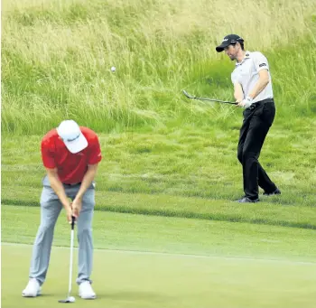  ?? RICHARD HEATHCOTE/GETTY IMAGES ?? Gregory Bourdy, of France, and Bradley Dredge, of Wales, shoot around before the practice round prior to the 2017 U.S. Open at Erin Hills, in Hartford, Wis.