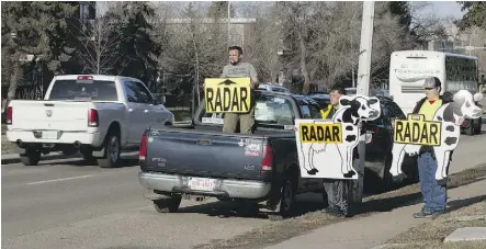  ?? DAVID BLOOM ?? Members of a group called the Alberta Cash Cows warn motorists about a photo radar location along Whyte Avenue near 98 Street a couple of weeks ago.