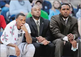  ?? FRED BECKHAM/AP PHOTO ?? In this Feb. 16, 2013, file photo, UConn assistant coaches Kevin Freeman, right, and Ricky Moore look on with Ryan Boatright during a game against Villanova in Hartford.