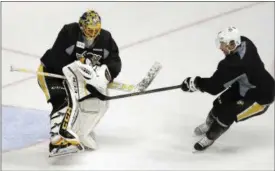  ?? THE ASSOCIATED PRESS FILE ?? Penguins goalie Marc-Andre Fleury, left, blocks a shot by center Sidney Crosby during a June 4 practice, in Nashville, Tenn.