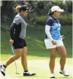  ?? Sean M. Haffey / Getty Images ?? Ariya Jutanugarn (left) joins her sister on the 12th green.