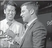  ?? Luis Sinco Los Angeles Times ?? ANDREW FRIEDMAN, with Kenta Maeda in 2016, says the Dodgers want to spend money smartly.