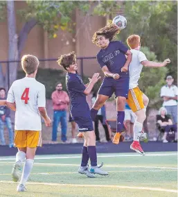  ??  ?? Santa Fe High’s Sebastian Lopez heads the ball during a Sept. 18 match against Taos.