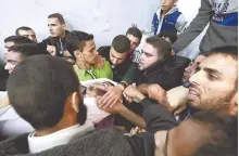  ?? EPA-Yonhap ?? Mourners carry the body of a man, who was killed with other Palestinia­n fighters in a tunnel in southern Gaza Strip, Monday.