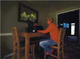  ?? CHARLIE RIEDEL — THE ASSOCIATED PRESS ?? Keli Paaske searches for jobs online from the dining room of her home in Olathe, Kan., on Friday. Paaske was laid off in August from a company supplying fire doors to hospitals.