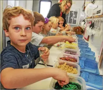  ??  ?? East Coventry Elementary School kindergart­en students make charms to represent that pizza ingredient­s first come from a farm.