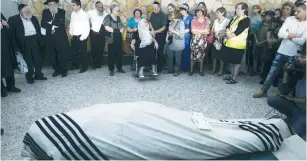  ?? (Baz Ratner/Reuters) ?? JERUSALEM BUS attack victim Alon Govberg’s wheelchair ridden mother mourns the 51-year-old at his funeral yesterday, attended by hundreds.