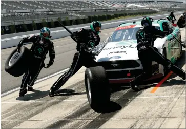  ?? AP PHOTO BY MATT SLOCUM ?? Crew members hustle to service the car of Austin Cindric in a pit stop during the NASCAR Xfinity Series auto race at Pocono Raceway, Sunday, June 28, 2020, in Long Pond, Pa.