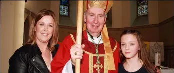  ??  ?? Bishop Denis Brennan with Veronica Redmond and her daughter, Roisin at the Monaseed NS confirmati­on at St. Patrick’s Church last March, the week before the country went into lockdown.