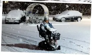  ??  ?? Icy: A woman makes her way through the snow in Filey, North Yorkshire