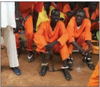  ?? AP ?? Prisoners sit bound together at the central prison in Juba, South Sudan, in this undated photo.