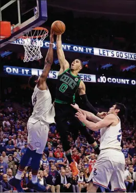  ?? MATT SLOCUM/THE ASSOCIATED PRESS ?? Boston Celtics’ Jayson Tatum goes up to shoot between Philadelph­ia 76ers’ Joel Embiid, left, and Ersan Ilyasova, right, during the second half of Game 3 of a second-round NBA playoff series Saturday in Philadelph­ia.